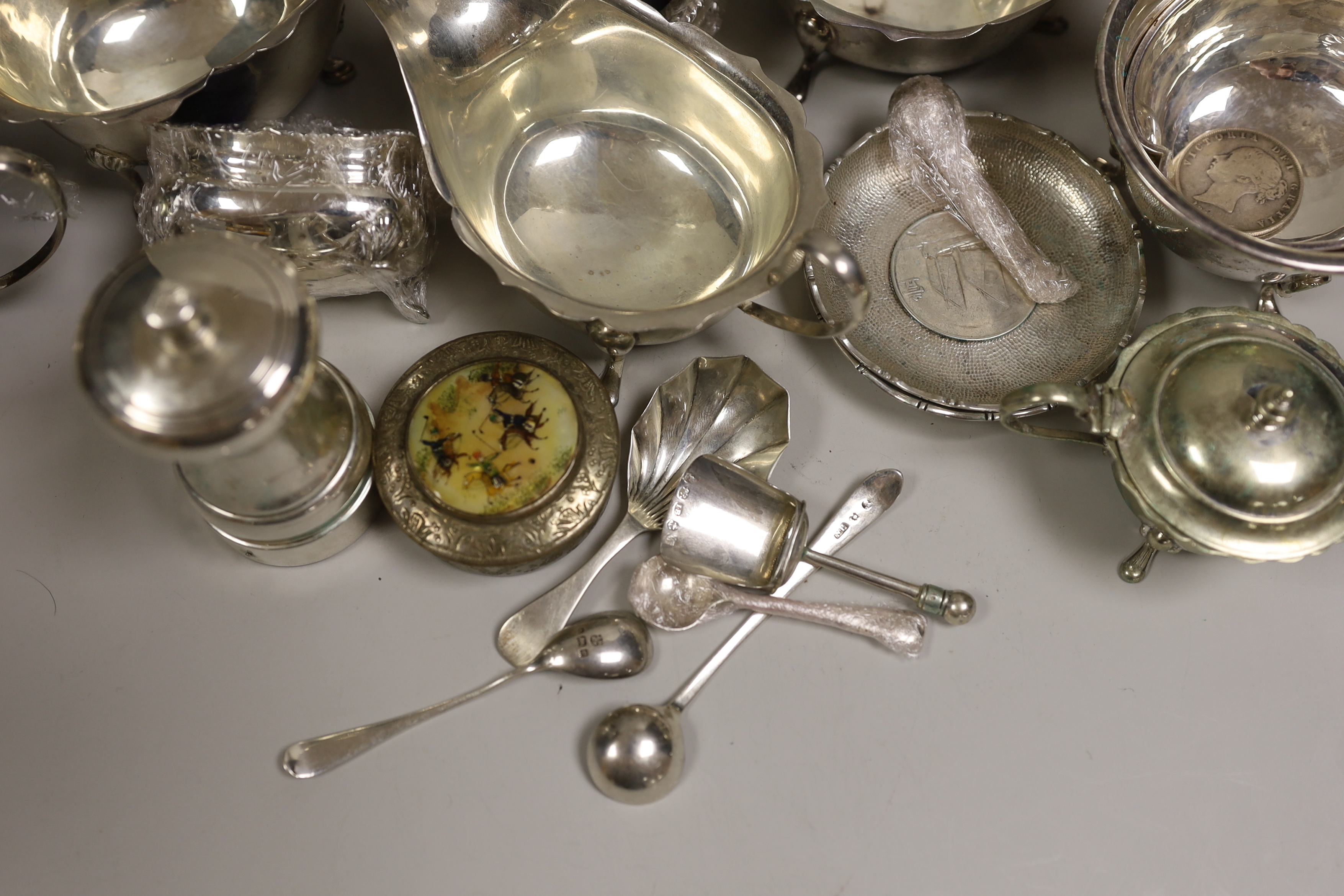 A mixed collection of small silver and plated items to include five various sauceboats, a cased pair of pepper pots, a chased Victorian sugar sifter, two caddy spoons, a silver mounted peppermill, two Chinese coin-set tr